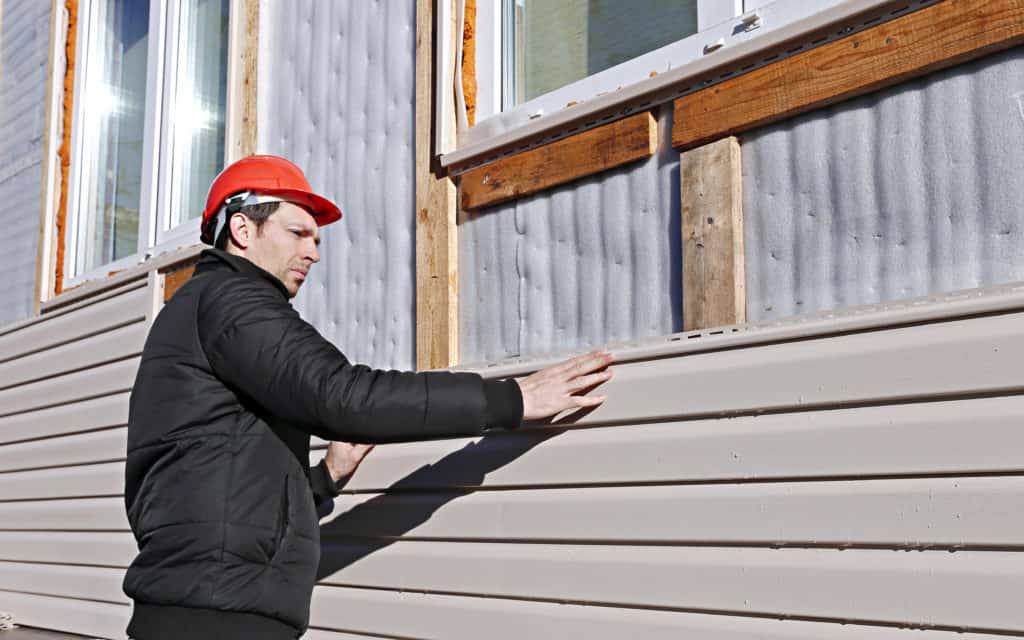 Siding Repair Minneapolis -Man Working on Replacing Siding