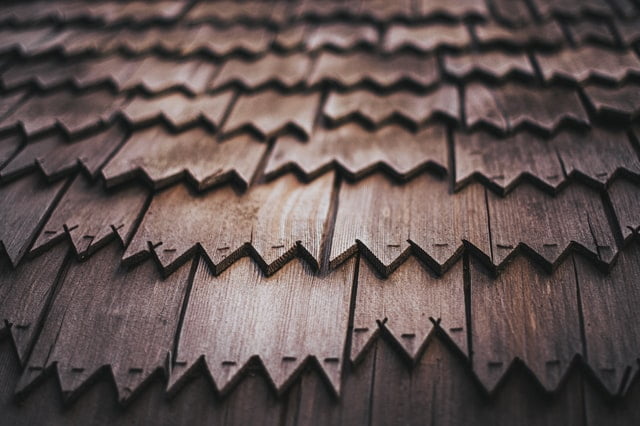 An image of a roof with wooden shingles.