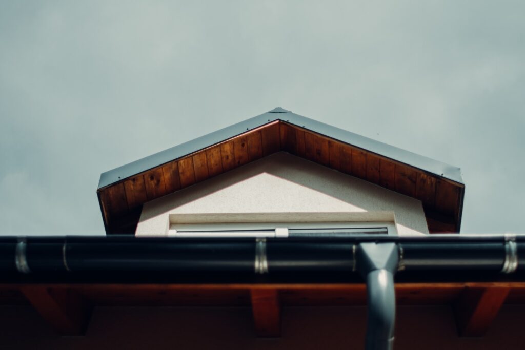 The gutters attached to the roof.