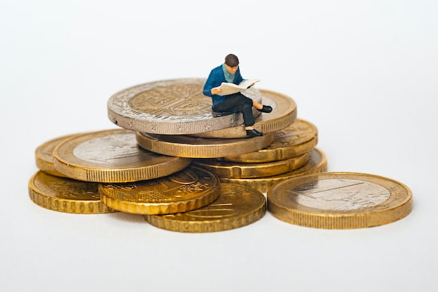 A person sitting on coins.