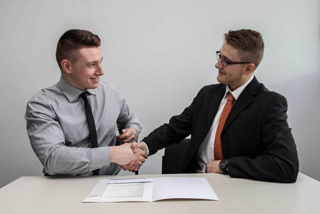 Two people shaking hands.