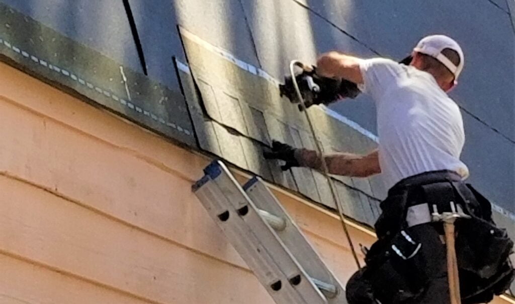 Why Minneapolis Homeowners Should Avoid National Roofers A Man Roofing a Roof