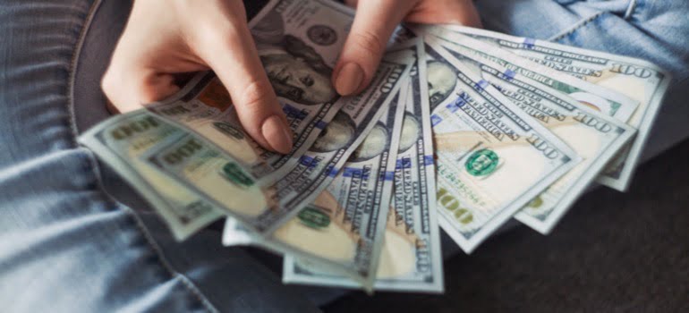 A person holding dollar bills