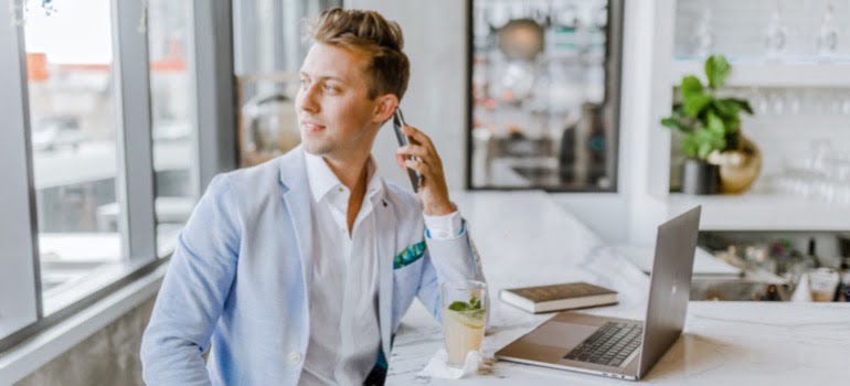 A man in a suit talking on the phone