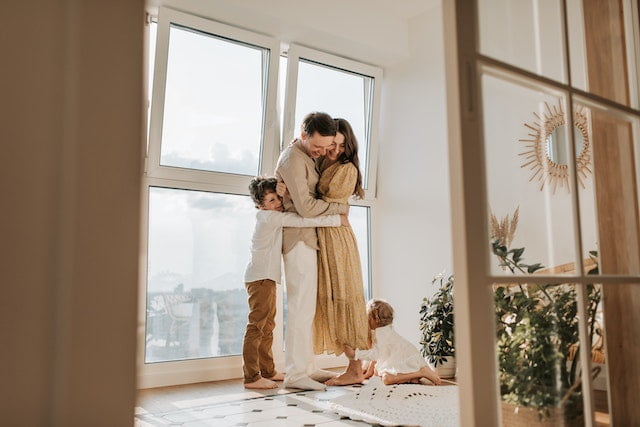 Family hugging after realizing the importance of a home inspection for new homeowners.